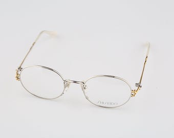 Shiseido 1001 2, Vintage 90s gold & silver unique oval eyeglasses frames womens NOS