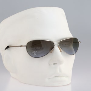 Calvin Klein 2028 29, Vintage 90s silver wrap aviator sunglasses men & women NOS