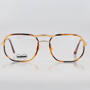 May include: Tortoiseshell and gold-tone metal eyeglasses with a rectangular frame. The brand name "MORWEN" is printed on the right lens.