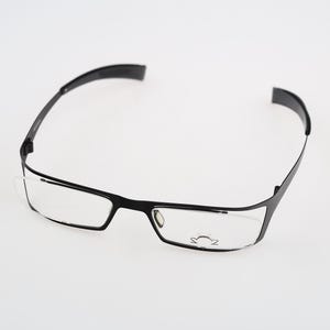 May include: Black eyeglasses with a thin, modern frame and clear lenses.