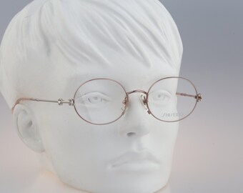 Shiseido 1001 3, Vintage 90s silver unique oval eyeglasses frames womens NOS