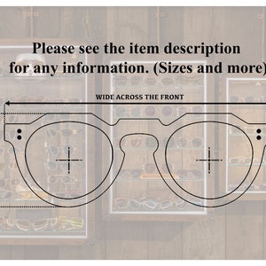 May include: Line drawing of a pair of round glasses with a wide front. The drawing shows the vertical height of the frame and the width across the front. The text "Please see the item description for any information. (Sizes and more)" is above the drawing.