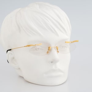 MCS 299 165, Vintage 90s gold crazy rimless small oval eyeglasses frames womens NOS