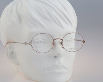 Shiseido 1001 3, Vintage 90s silver unique oval eyeglasses frames womens NOS
