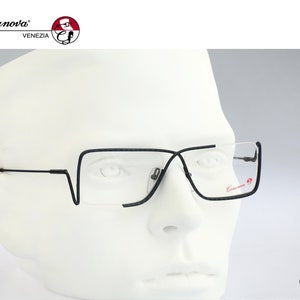 May include: Black framed glasses with a thin metal frame and clear lenses. The glasses are on a white mannequin head. The brand name "Casanova" is visible on the frame.