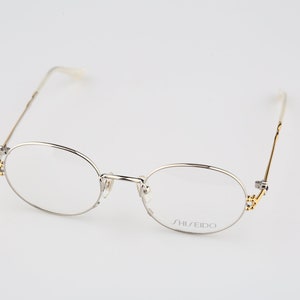 Shiseido 1001 2, Vintage 90s gold & silver unique oval eyeglasses frames womens NOS