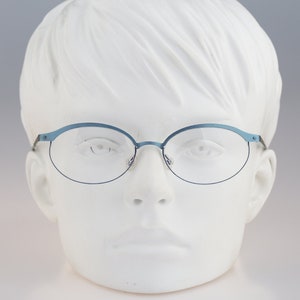 It&#39;s Titanium 603, Vintage 90s laser cut ultra lightweight nylor blue oval eyeglasses frames women / NOS