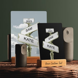 May include: Two street sign prints with the names "Sam" and "Kate" on them. The signs are set on wooden stands with a small wooden sign that says "Your Custom Text".