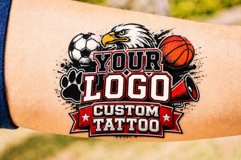 May include: A temporary tattoo featuring a central eagle head, a soccer ball, a basketball, a megaphone, and a paw print. The design includes the text YOUR LOGO and CUSTOM TATTOO in bold white and red lettering on a red banner with two white stars.