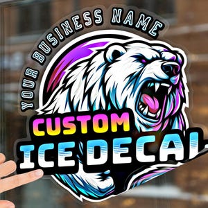 May include: A custom ice decal with a white polar bear with a pink tongue roaring. The decal has a black background with the text "YOUR BUSINESS NAME" in a white circle around the bear. The text "CUSTOM ICE DECAL" is in a rainbow gradient.