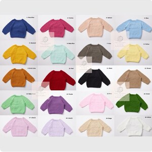 May include: A collection of twenty knitted sweaters in various colors, including navy blue, fuchsia, salmon, and blue. Each sweater has a crew neck and long sleeves. The sweaters are arranged in rows and columns, with color names labeled above each.