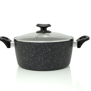 May include: A black pot with a glass lid and black handles. The pot has a speckled, granite-like finish.
