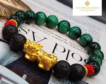 May include: A green and black beaded bracelet with a gold Chinese dragon charm. The bracelet is made with lava rock and green agate beads. The text "Love4DiamondGold Fine Jewelry Collection" is visible in the top right corner of the image.