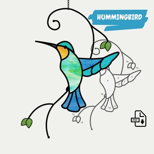 K&ouml;nnte beinhalten: Ein Buntglasmuster eines Kolibris auf einem Zweig mit Bl&auml;ttern. Das Muster ist f&uuml;r ein Buntglasprojekt nummeriert. Der Text "HUMMINGBIRD" ist oben im Bild in Blau.