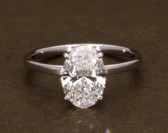 Anillo de compromiso con diamante de laboratorio de talla ovalada, color D, pureza VVS2, certificado por IGI. Solitario con halo oculto.