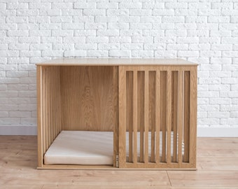 May include: A wooden dog crate with a slatted front and a removable bed. The crate is made of natural wood and has a light brown finish.