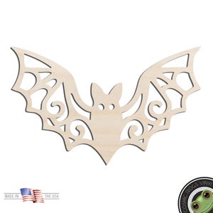 May include: A wooden bat cutout with intricate wing designs and a central body. The bat is made of light-colored wood and is suitable for crafting or Halloween decorations. The text "MADE IN THE USA" is visible.