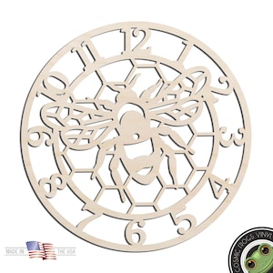 May include: A wooden clock face with a bee and honeycomb design. The clock face is unfinished and ready to be painted or stained. The numbers 1 through 12 are visible around the edge of the clock face.