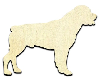 May include: A flat, laser-cut wooden cutout in the silhouette of a Rottweiler dog. The object features a light beige, natural wood grain texture with a smooth finish, depicting the dog standing in profile facing toward the right side.