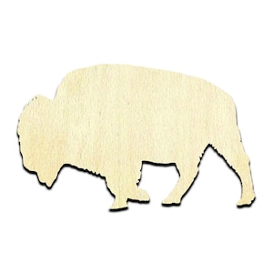 May include: A wooden cutout of a bison, a large, shaggy mammal with horns. The cutout is light brown and has a simple, silhouette-like design.