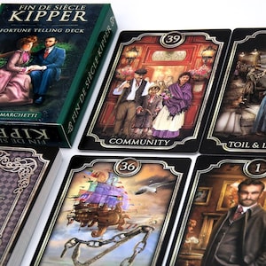 May include: A Fin de Siècle Kipper fortune telling deck with a green box and several cards. The box has the title in white and gold lettering. The cards feature illustrations with numbers and titles like "Community" and "Toil & L".