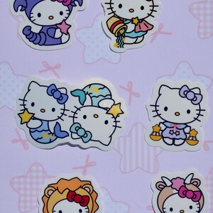 May include: Set of 6 Hello Kitty zodiac stickers featuring different zodiac signs, including a purple scorpion, a blue water bearer, a blue fish, a purple scale, a yellow lion, and a brown goat.