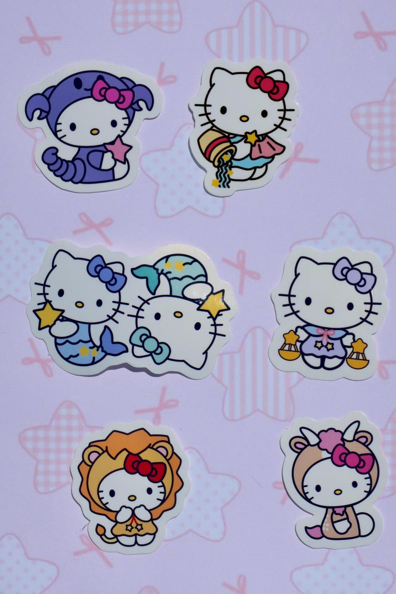 May include: Set of 6 Hello Kitty zodiac stickers featuring different zodiac signs, including a purple scorpion, a blue water bearer, a blue fish, a purple scale, a yellow lion, and a brown goat.