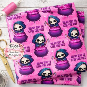 May include: Pink fabric with a repeating pattern of a Grim Reaper stirring a cauldron. The text "ON MY WAY TO STIR THE POT" is also printed on the fabric. A spool of pink thread and gold scissors are in the background.