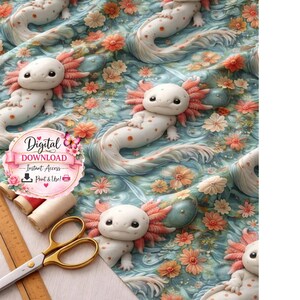 May include: A fabric design featuring multiple white axolotls with pink gills and orange spots, set against a light blue background with orange and cream-colored flowers. The image includes a pair of gold scissors, a ruler, and spools of thread.