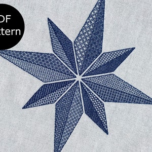 May include: A blue, eight-pointed star with a geometric pattern, embroidered on a white fabric. The text "PDF pattern" is in a black circle in the top left corner.