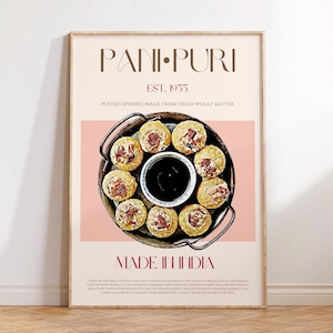 May include: A framed print featuring the text "PANI PURI EST. 1955" above a photo of the Indian snack. The image shows puffed spheres made from fried wheat batter, with a dark sauce in the center. The words "MADE IN INDIA" are at the bottom.