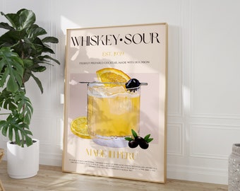 May include: A vintage-style poster with a gold frame advertising a whiskey sour cocktail. The poster features a glass of whiskey sour with a lemon wedge and a maraschino cherry. The text on the poster reads "Whiskey Sour Est. 1939 Freshly Prepared Cocktail Made With Bourbon Made In Peru".