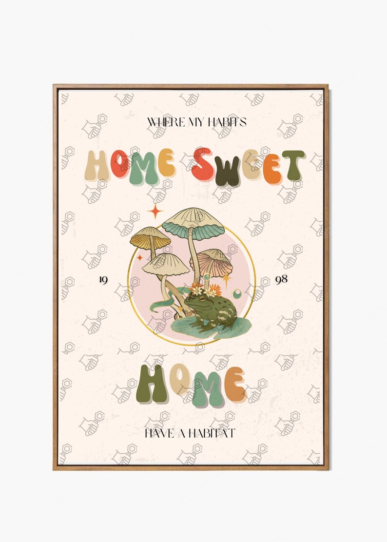 May include: A framed art print with a whimsical design. The artwork features the words "HOME SWEET HOME" in colorful, retro-style lettering, along with illustrations of mushrooms and a frog. The background has a repeating pattern of hand-like shapes.