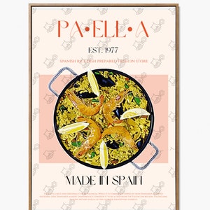 May include: A poster with a peach background and a brown frame. The poster features a large illustration of a pan of paella with shrimp, mussels, and lemon wedges. The text "PA.ELLE.A EST. 1977 SPANISH RICE DISH PREPARED FRESH IN STORE MADE IN SPAIN" is printed in red and black.