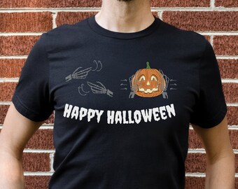 Może przedstawiać: Czarny T-shirt z grafiką białej dyni i szkieletowych rąk. Pod grafiką znajduje się napis "Happy Halloween".