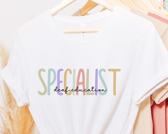 May include: White t-shirt with the text "SPECIALIST deaf education" in colorful letters.