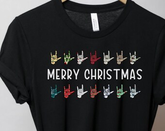 May include: Black t-shirt with a row of colorful hand signs spelling "Merry Christmas" in American Sign Language.