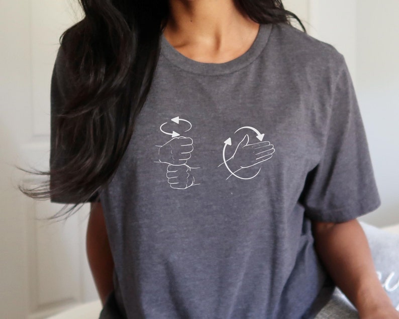 May include: A dark gray t-shirt with a white graphic of two hands demonstrating the ASL sign for "I love you".