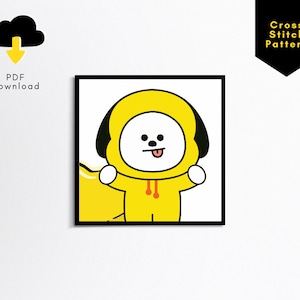 May include: A cross stitch pattern featuring a cartoon dog wearing a yellow hoodie. The dog has a black nose, black eyes, and a pink tongue sticking out. The dog is standing on a white background.