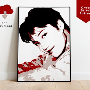 May include: Cross stitch pattern of a person with black hair and red and white clothing. The person is looking down and to the right.