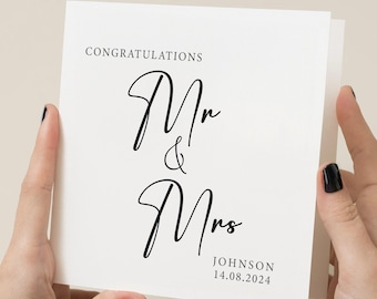 Puede incluir: Tarjeta blanca con caligrafía negra que dice "Felicidades Mr & Mrs JOHNSON 14.08.2024".