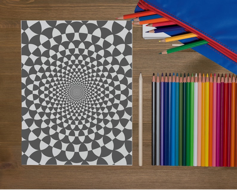 May include: A black and white coloring page with a spiral pattern of circles and triangles. The page is surrounded by a wooden table and a pencil case with colored pencils.