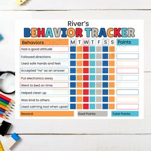 May include: A white paper behavior tracker chart titled River's BEHAVIOR TRACKER with colorful text. It features a list of behaviors, a weekly grid with columns for M, T, W, T, F, S, S, and empty boxes for points, reward, goal points, and total points.