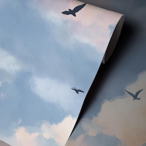 May include: A roll of wallpaper featuring a sky scene with clouds and flying birds. The color palette includes shades of blue, gray, and pink. The birds are silhouetted against the sky.