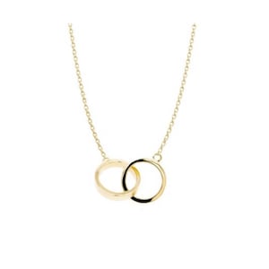 May include: A gold necklace with a pendant featuring two interlocking circles.