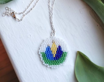 Handwoven folk tulip disc, pendant necklace on silver chain, white & blue