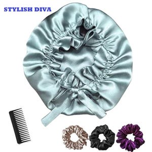 May include: A light teal satin bonnet with a bow, a black comb, and three scrunchies in tan, black, and purple. The bonnet has the text "STYLISH DIVA" in the upper left corner. The bonnet is designed to protect hair while sleeping.