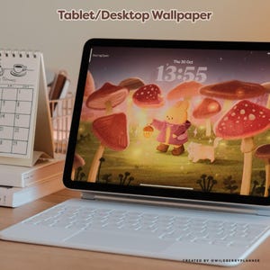 May include: A tablet with a white keyboard displaying a whimsical wallpaper featuring a cartoon rabbit and cat in a mushroom forest. The screen shows the date and time. Text at the top reads "Tablet/Desktop Wallpaper".