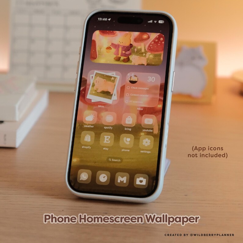 May include: A smartphone displaying a custom homescreen wallpaper with a whimsical forest scene, featuring a cartoon character and mushrooms. The phone is in a white case and is propped up on a stand. Text on the screen includes app icons and the words "Phone Homescreen Wallpaper".