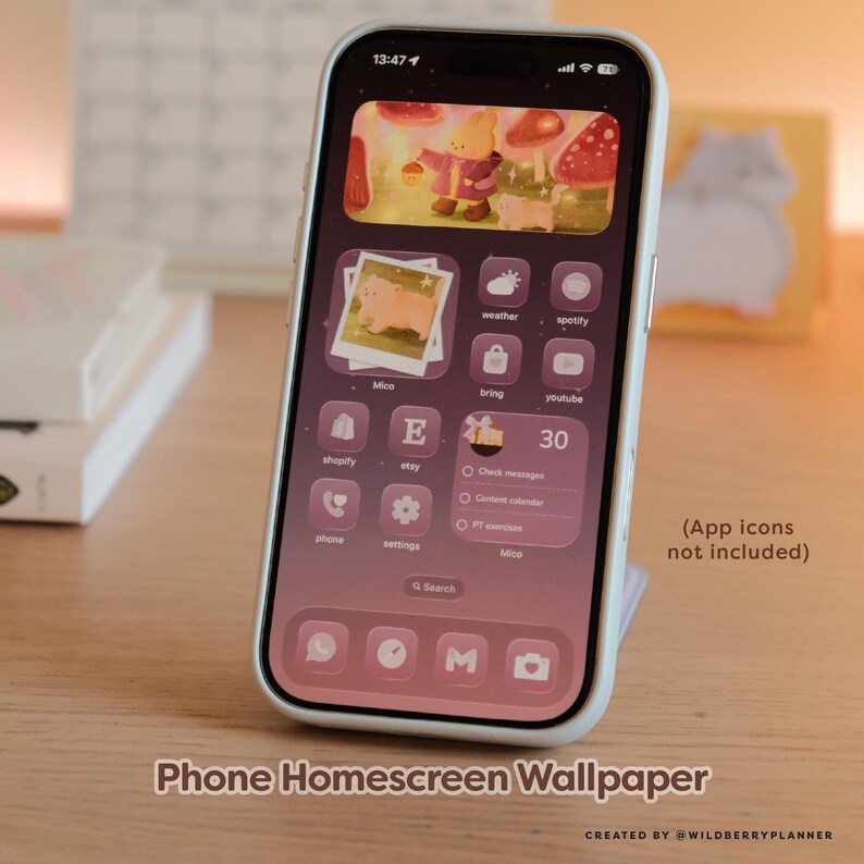 May include: A smartphone with a pink and purple homescreen wallpaper featuring a cartoon bear, mushrooms, and app icons. The phone is in a white case and is propped up on a stand. Text on the screen reads "Phone Homescreen Wallpaper".